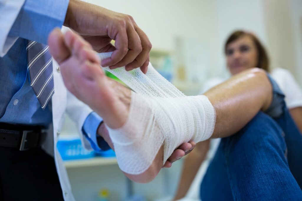 Doctor wrapping patient wound